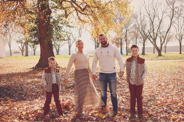 Mike and Andon Filsinger with their two sons among autumn trees